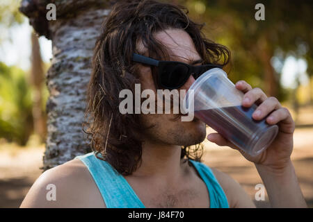 Unconscious man drinking beer in the park Stock Photo