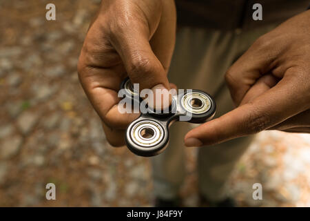 Close-up of a man hand s holding a fidget spinner Stock Photo