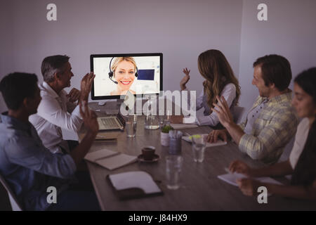 Business people talking to expert through video conference in office Stock Photo