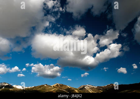 Cloudy skies over mountain tops. Stock Photo