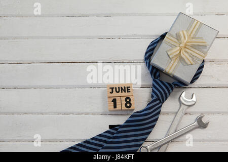 Overhead view of calender date by gifts for fathers day on wooden table Stock Photo