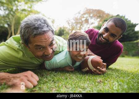 Portrait of multi generation family playing rugby at park Stock Photo