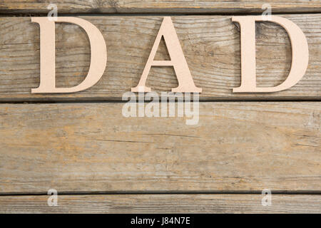 Overhead view of dad text on wooden table Stock Photo