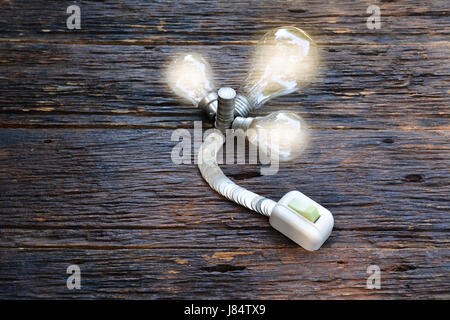 open switch for turn on light in bulb light and coins for idea and save money Stock Photo