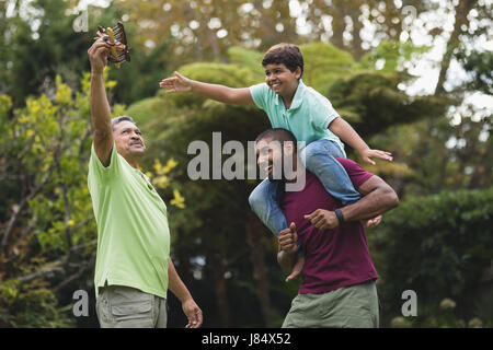 Happy multi generation family enjoying at park Stock Photo