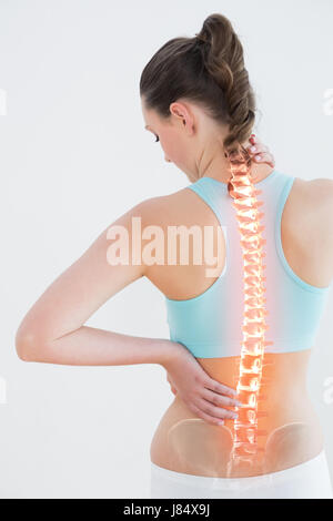 Rear view of woman suffering from pain against white background Stock Photo