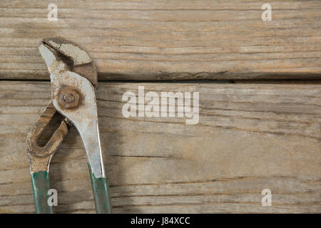 Overhead view of adjustable pliers on wooden table Stock Photo