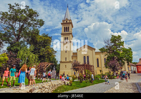 Sighisoara, Romania - July 26, 2014: Tourists come to visit the Saint Joseph Roman-Catholic Cathedral. Stock Photo