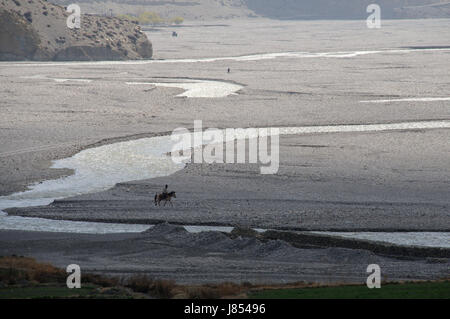 asia ravine river bed nepal mustang himalayas travel stone horse hike go hiking Stock Photo