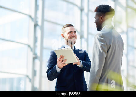 Successful traders discussing financial data online Stock Photo