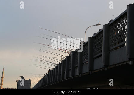 ISTANBUL, TURKEY - MAY 19, 2017: Fishermen fishing on Galata Bridge. Galata Bridge is the most popular destinations for entertainment and travel of Is Stock Photo