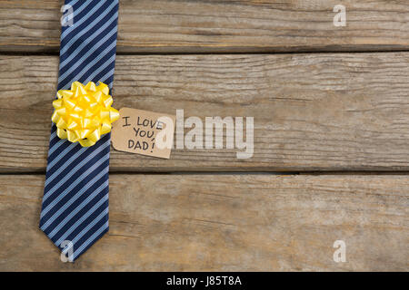Overhead view of necktie with greetings on wooden table Stock Photo