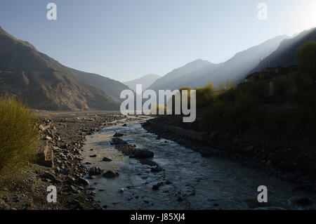 asia ravine river bed nepal mustang himalayas blue travel tree stone hike go Stock Photo