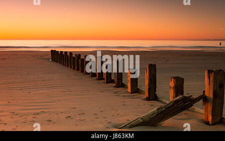 golden sky during sunset at barmouth beach, wales, uk Stock Photo