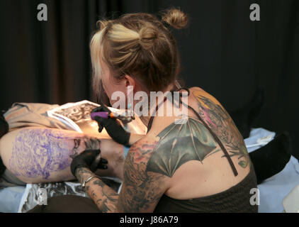 London, UK. 27th May, 2017. The Great Hall in Alexandra palace was once again filled with the sound of needles and the air was heavy with the smell of Ink, as tattoo enthusiasts from all over Britain and abroad come to get inked and to enjoy the variety of entertainment at the show, from music to food to colourful runway shows and cabaret acts  Credit: Paul Quezada-Neiman/Alamy Live News Stock Photo
