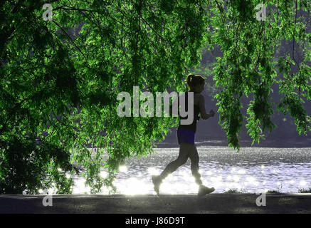 Berlin, Germany. 27th May, 2017. A woman jogs along the river Spree in the morning hours in Berlin, Germany, 27 May 2017. Photo: Paul Zinken/dpa/Alamy Live News Stock Photo