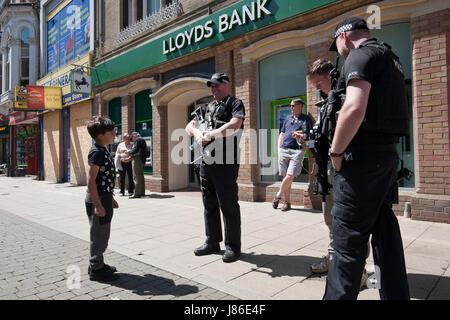 Lowestoft, UK. 24th May, 2017. Armed police officers a reassuring and friendly presence amongst Bank Holiday shoppers in Lowestoft town centre.  © Adrian Buck / Alamy Live News. Stock Photo