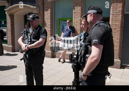 Lowestoft, UK. 24th May, 2017. Armed police officers a reassuring and friendly presence amongst Bank Holiday shoppers in Lowestoft town centre.  © Adrian Buck / Alamy Live News. Stock Photo