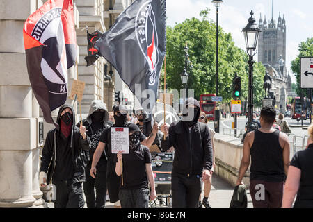 London, UK. 27th May, 2017. A small group of anti-fascists and anarchists march through Whitehall as part of an anti-Tory party protest prior to the upcoming general election. © Guy Corbishley/Alamy Live News