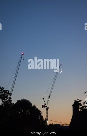 Tottenham, London, UK. 27th May, 2017. A thin crescent moon appears to be caught by the jib of a crane over the Tottenham Hotspur stadium building site. Credit: Patricia Phillips/ Alamy Live news Stock Photo