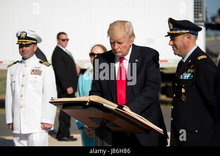 U.S. President Donald Trump signs the Albo d’Onore, the Sigonella Italian Air Force base guest book during a stopover to visit Naval Air Station Sigonella before returning home from his nine-day overseas trip May 27, 2017 in Sigonella, Italy. Stock Photo