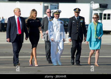 Capt. Brent Trickel, commanding officer of NAS Sigonella, center, Col. Federico Fedele, Italian base commander for NAS Sigonella, and Kelly Degnan, the Chargé d’Affaires at the U.S. embassy in Rome, escort First Lady Melania Trump and President Donald Trump to board Air Force One following a visit with service members at Naval Air Station Sigonella before returning home from his nine-day overseas trip May 27, 2017 in Sigonella, Italy. Stock Photo