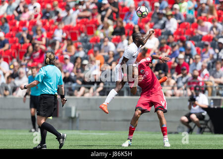 Ottawa, Canada. 27th May, 2017. Richmond Kickers Fred Owusu Sekyere (4) jumps over Ottawa Fury FC Onua Thomas Obasi (14) during the USL match between Richmond Kickers and Ottawa Fury FC at TD Place Stadium in Ottawa, Canada. Ottawa Fury FC won the match by a score of 5-3. Daniel Lea/CSM/Alamy Live News Stock Photo