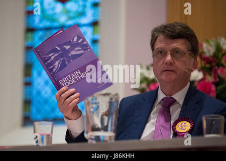 Maidenhead, UK. 27th May, 2017. Gerard Batten, UKIP candidate for the Maidenhead constituency, holds up the UKIP Manifesto as he answers a question at a hustings event for the forthcoming general election at the High Street Methodist Church. Credit: Mark Kerrison/Alamy Live News Stock Photo