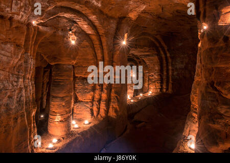 Using T lights to illuminate the underground chambers of Caynton Caves, near Shifnal, Shropshire, England, UK. Stock Photo