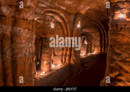 Using T lights to illuminate the underground chambers of Caynton Caves, near Shifnal, Shropshire, England, UK. Stock Photo