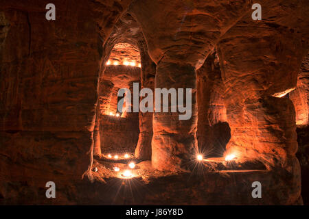 Using T lights to illuminate the underground chambers of Caynton Caves, near Shifnal, Shropshire, England, UK. Stock Photo