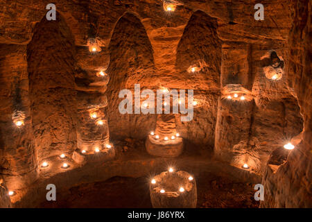 Using T lights to illuminate the underground chambers of Caynton Caves, near Shifnal, Shropshire, England, UK. Stock Photo