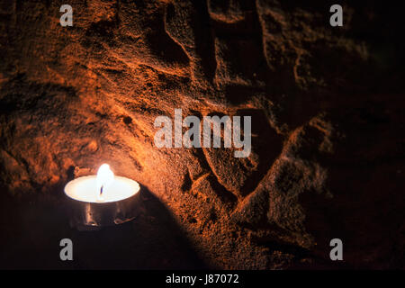 Using T lights to illuminate the underground chambers of Caynton Caves, near Shifnal, Shropshire, England, UK. Stock Photo