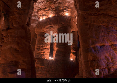 Using T lights to illuminate the underground chambers of Caynton Caves, near Shifnal, Shropshire, England, UK. Stock Photo