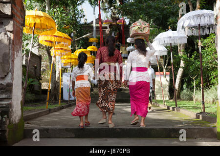 UBUD, INDONESIA - MARCH 2: Women walks up the stairs during the celebration before Nyepi (Balinese Day of Silence) on March 2, 2016 in Ubud, Indonesia Stock Photo