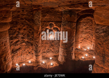 Using T lights to illuminate the underground chambers of Caynton Caves, near Shifnal, Shropshire, England, UK. Stock Photo