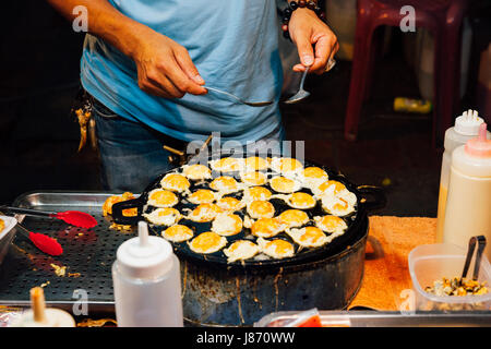 CHIANG MAI, THAILAND - AUGUST 21: Food vendor cook quail eggs at the Sunday Market (Walking Street) on August 21, 2016 in Chiang Mai, Thailand. Stock Photo