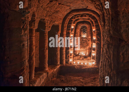 Using T lights to illuminate the underground chambers of Caynton Caves, near Shifnal, Shropshire, England, UK. Stock Photo