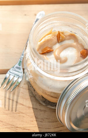Delicious Banoffee in Mason jar on wood background Stock Photo