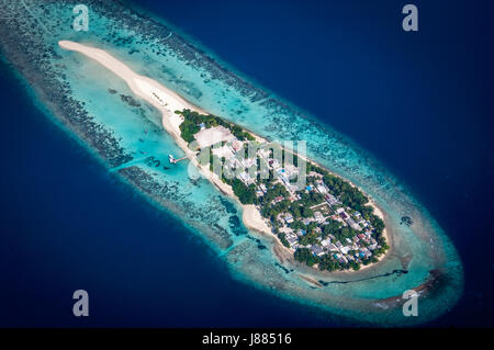 An island in an atoll chain seen from the air in the Maldives Stock Photo