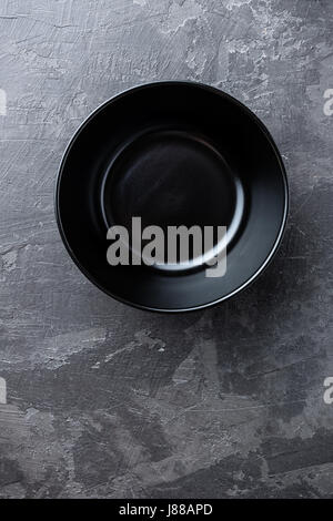 Empty black soup plate on dark grey background, top view Stock Photo