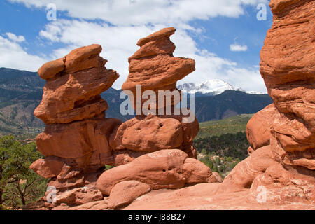 The Classic Overlook View of Garden of the Gods in Colorado Springs on a beautiful summer day with blue skies and white puffy clouds with Pikes Peak f Stock Photo
