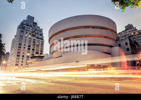 Goggenheim museum at night in New York City with traffic lights in front Stock Photo