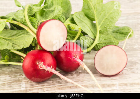 Juicy fresh radish in a cut on a white wooden background close up Stock Photo