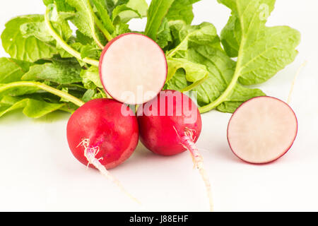Juicy fresh radish in a cut on a white wooden background close up Stock Photo
