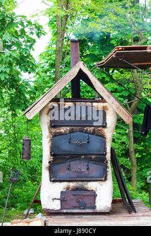 Old clay oven on traditional campfire in medieval knights camp Stock Photo