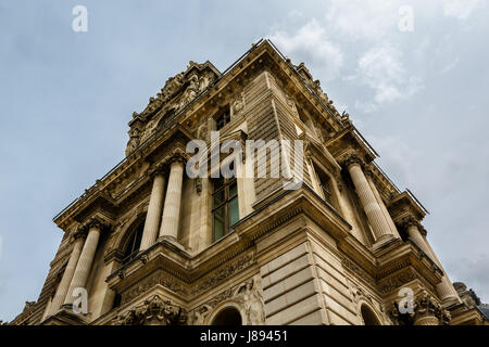 PARIS - JULY 1: Facade of Louvre Museum on July 1, 2013. The Louvre is one of the world's largest museums in Paris. Nearly 35,000 objects are exhibite Stock Photo
