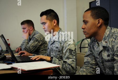 U.S. Air Force contracting specialists conduct an exercise at Hurlburt Field, Florida, reviewing vendor quotes to evaluate pricing, delivery schedules, and service options for operational procurement. Stock Photo