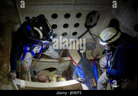 NAVAL SUPPORT FACILITY INDIAN HEAD, Md. – Cpl. Jeffrey A. Moultrie, rescue specialist, and Staff Sgt. Tyler W. Jennings, rescue officer, both with Technical Rescue Platoon, Chemical Biological Incident Response Force, CBIRF, US Marine Corps Forces Command, performed a confined space rescue aboard the USS Wisconsin, a US Navy battleship, during the Rescue Challenge 2017 at Virginia Beach, Va. May 1, 2017.  CBIRF’s Technical Rescue Platoon participated in the annual Rescue Challenge organized by the Technical Rescue Association of Virginia,  the Rescue Challenge is a high level multi-discipline  Stock Photo