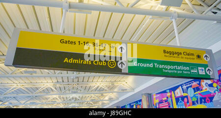 Direction signs at the airport for gates and baggage claim DALLAS - TEXAS - APRIL 10, 2017 Stock Photo